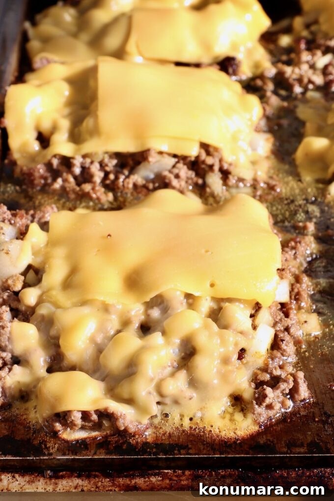 New York Bodega Chopped Cheese Sandwich Recipe 8 ground beef topped with slices of American cheese on a griddle