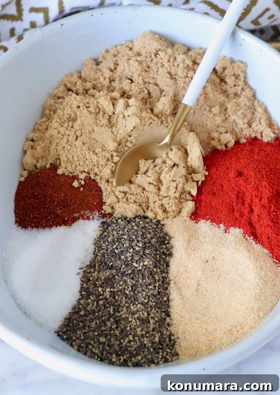 spices and brown sugar separated in a bowl with a spoon