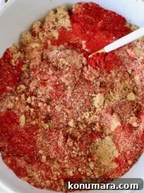 brown sugar and spices mixed together in a bowl with a spoon