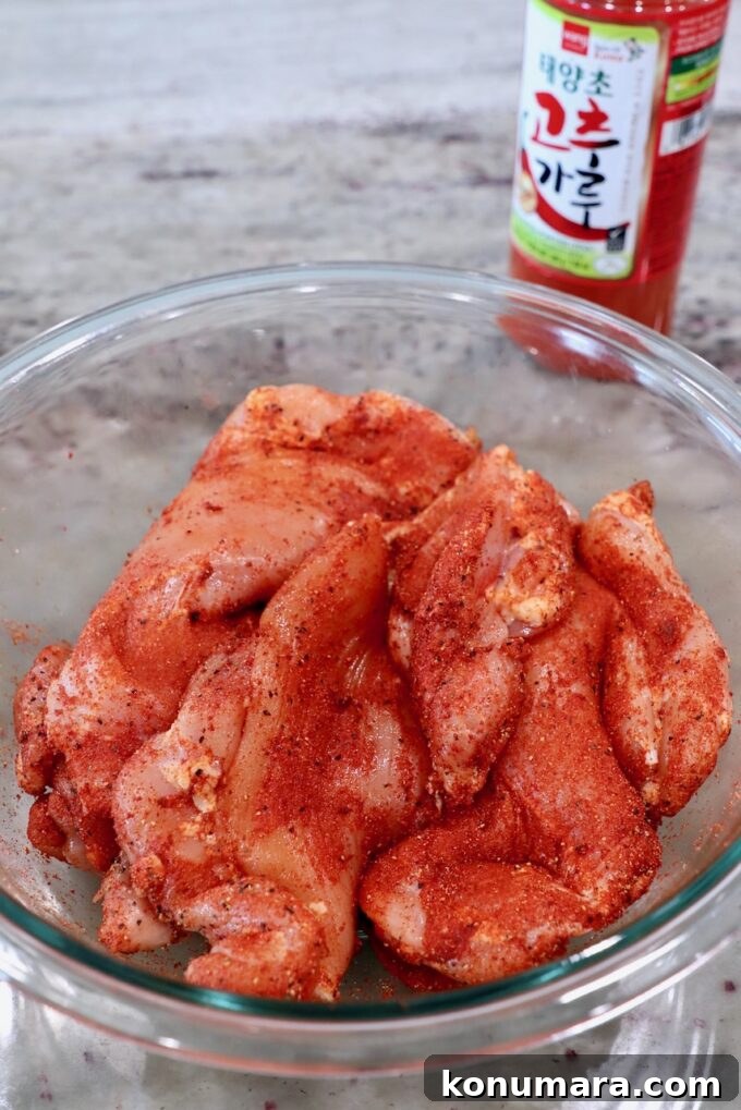 Korean BBQ Chicken with Gochujang Glaze 4 seasoned chicken thighs in a glass bowl