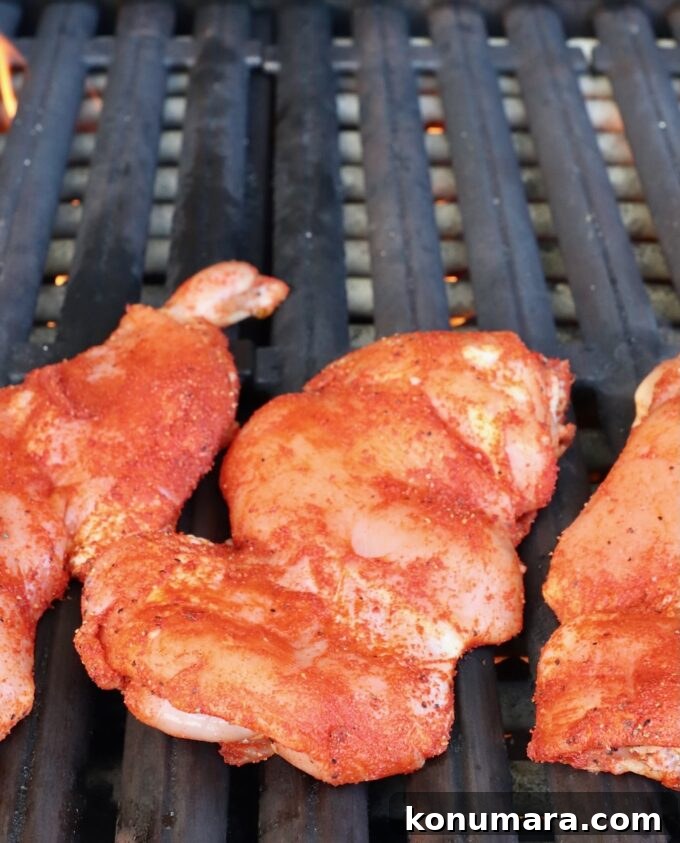 Korean BBQ Chicken with Gochujang Glaze 5 seasoned chicken thighs on a grill