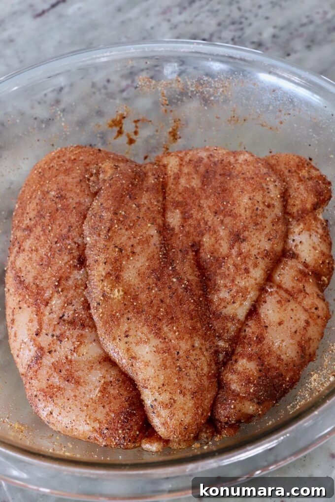 seasoned chicken breasts in a glass bowl