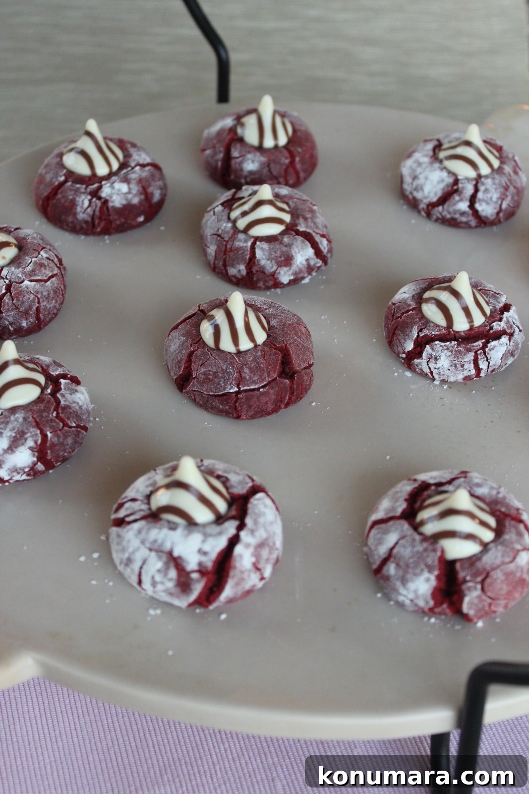 Valentines Day Red Velvet Cookies Red Velvet Cookies on a baking stone topped with Hershey's Hugs candies