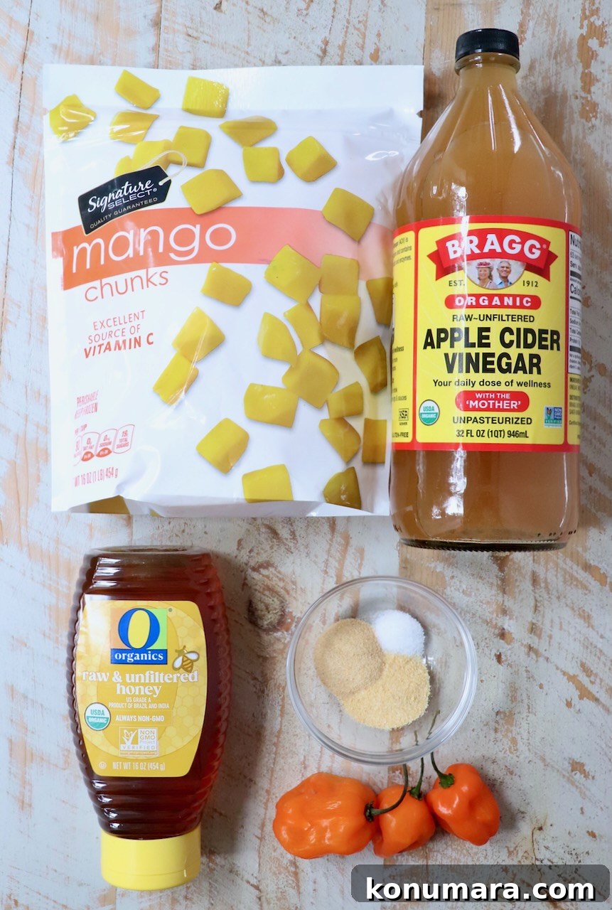 Mango Habanero Sauce Recipe for Wings and Grilled Meats 3 ingredients for mango habanero sauce on a white wood board