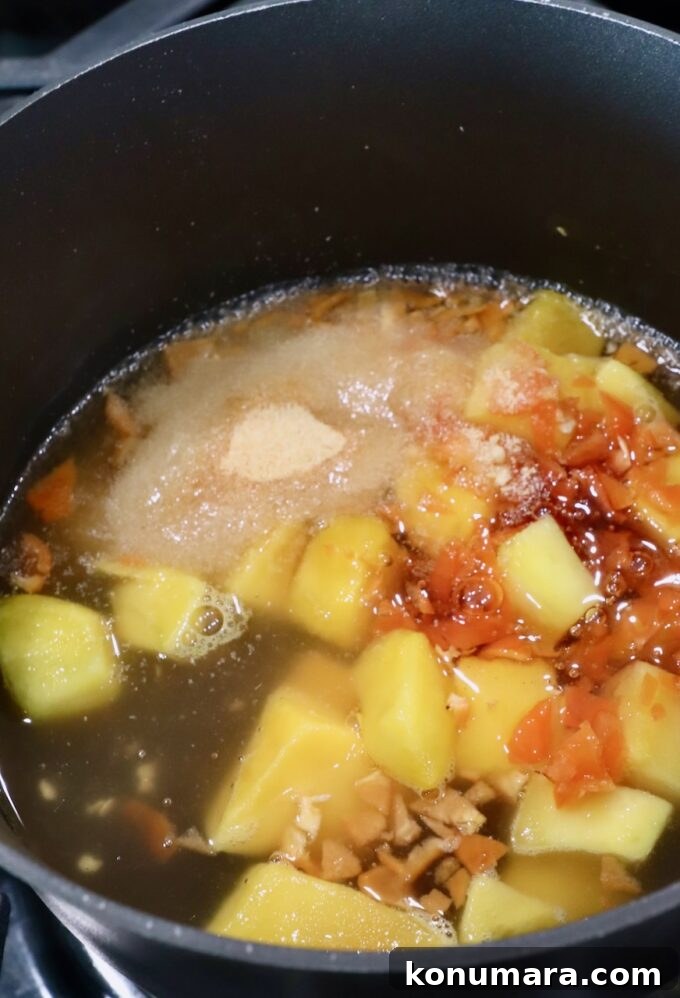 Mango Habanero Sauce Recipe for Wings and Grilled Meats 4 chunks of mango in a sauce pan with honey, vinegar, garlic powder and minced habanero peppers