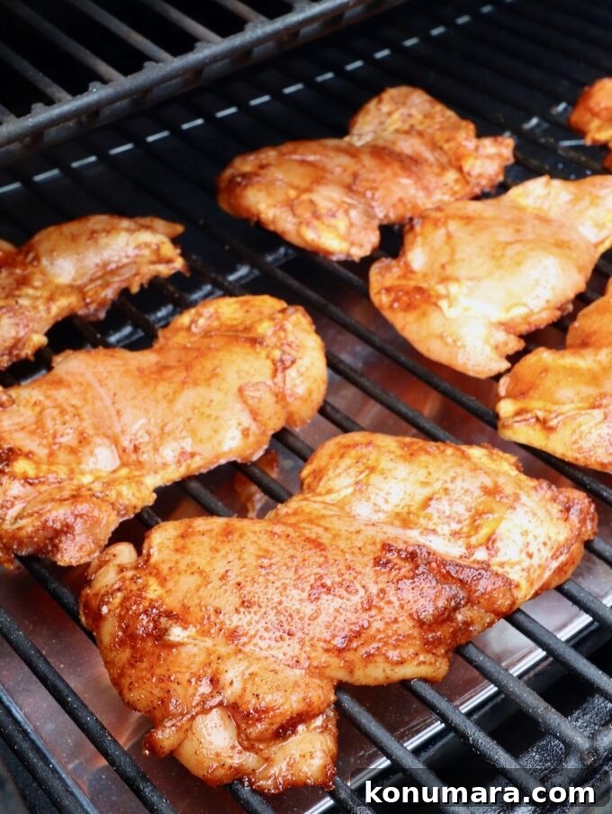 seasoned chicken thighs on a smoker