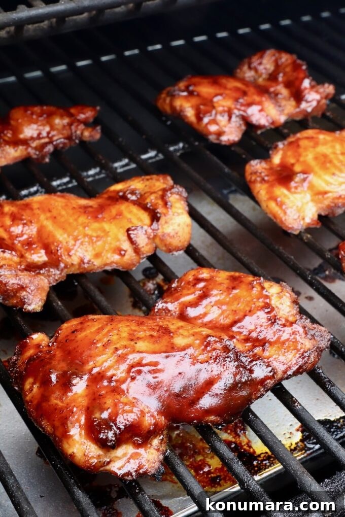 bbq sauce glazed smoked chicken thighs on a smoker