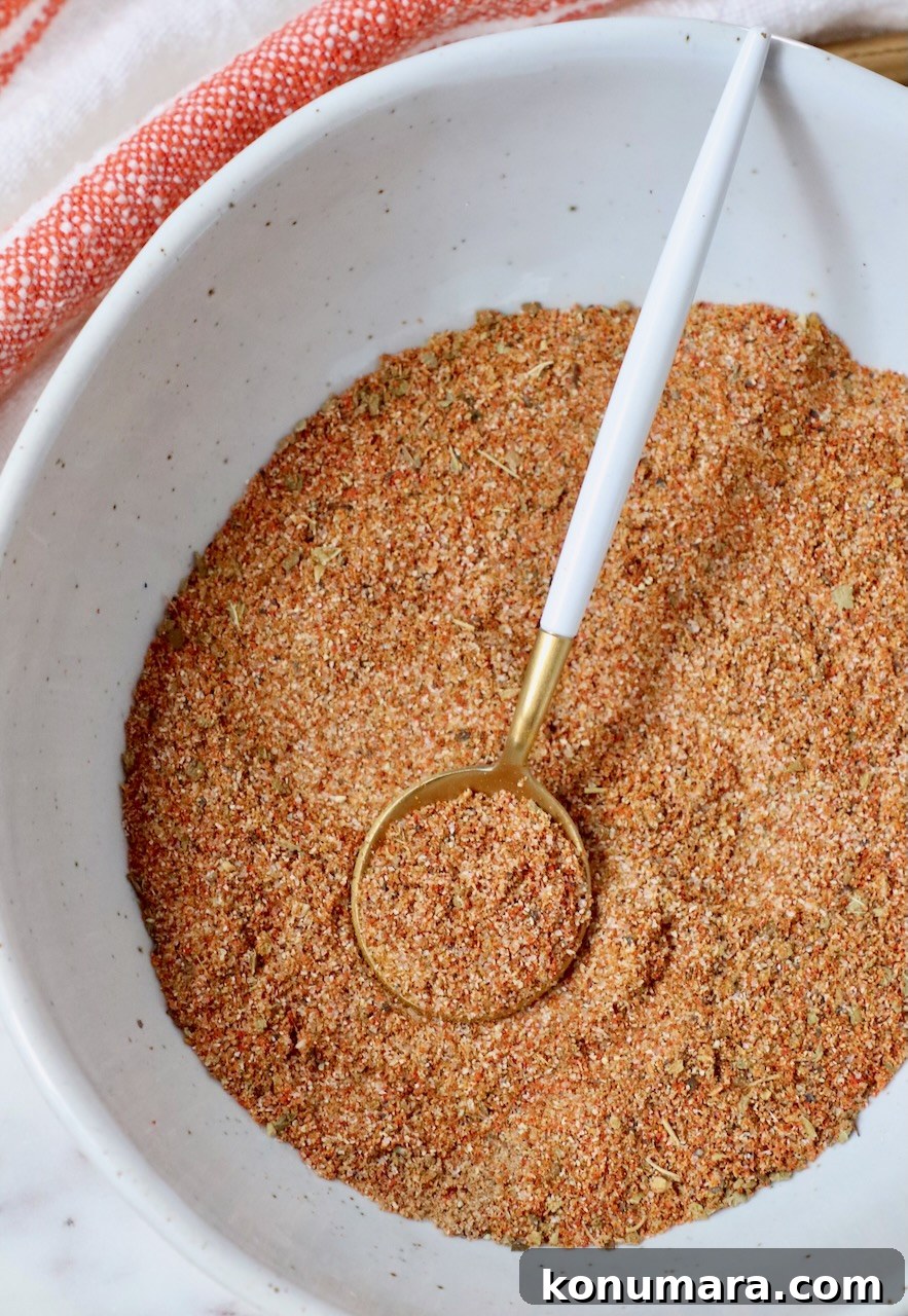 spices stirred together in a bowl with a small spoon