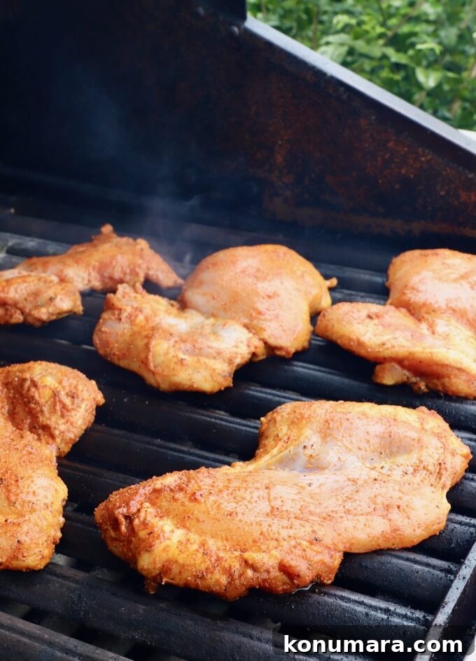 Juicy Grilled Sazon Chicken Thighs Recipe 5 seasoned chicken thighs on a grill
