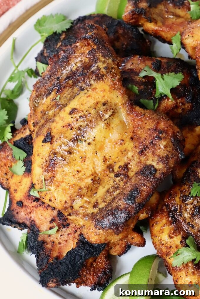 Juicy Grilled Sazon Chicken Thighs Recipe 7 grilled chicken thighs stacked up on a plate