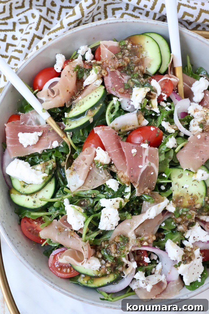 Cucumber, Arugula and Prosciutto Salad with Lemon Vinaigrette 2 salad in a bowl with prosciutto, cucumber, tomatoes and feta cheese
