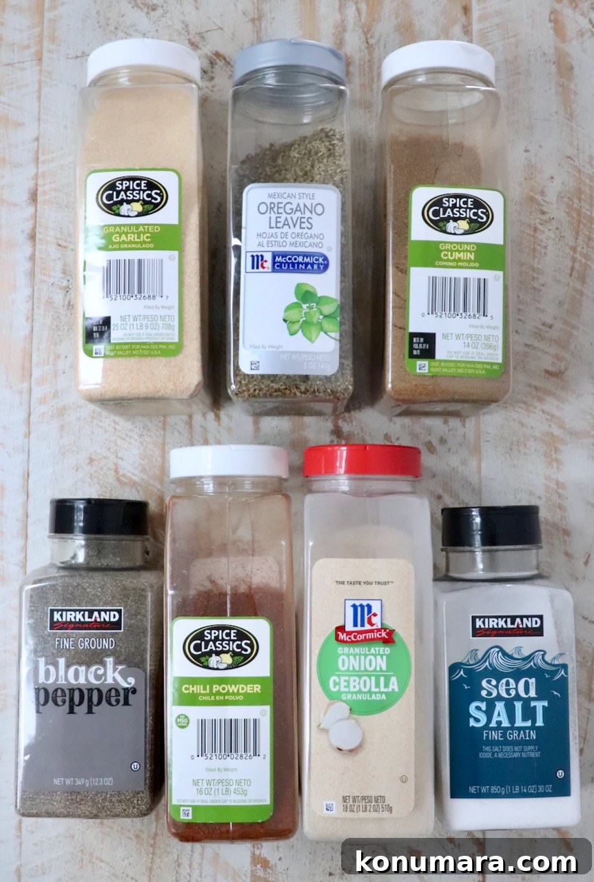 Authentic Carnitas Seasoning Recipe for Tender Pork 3 spices in plastic containers lined up on a white wood board
