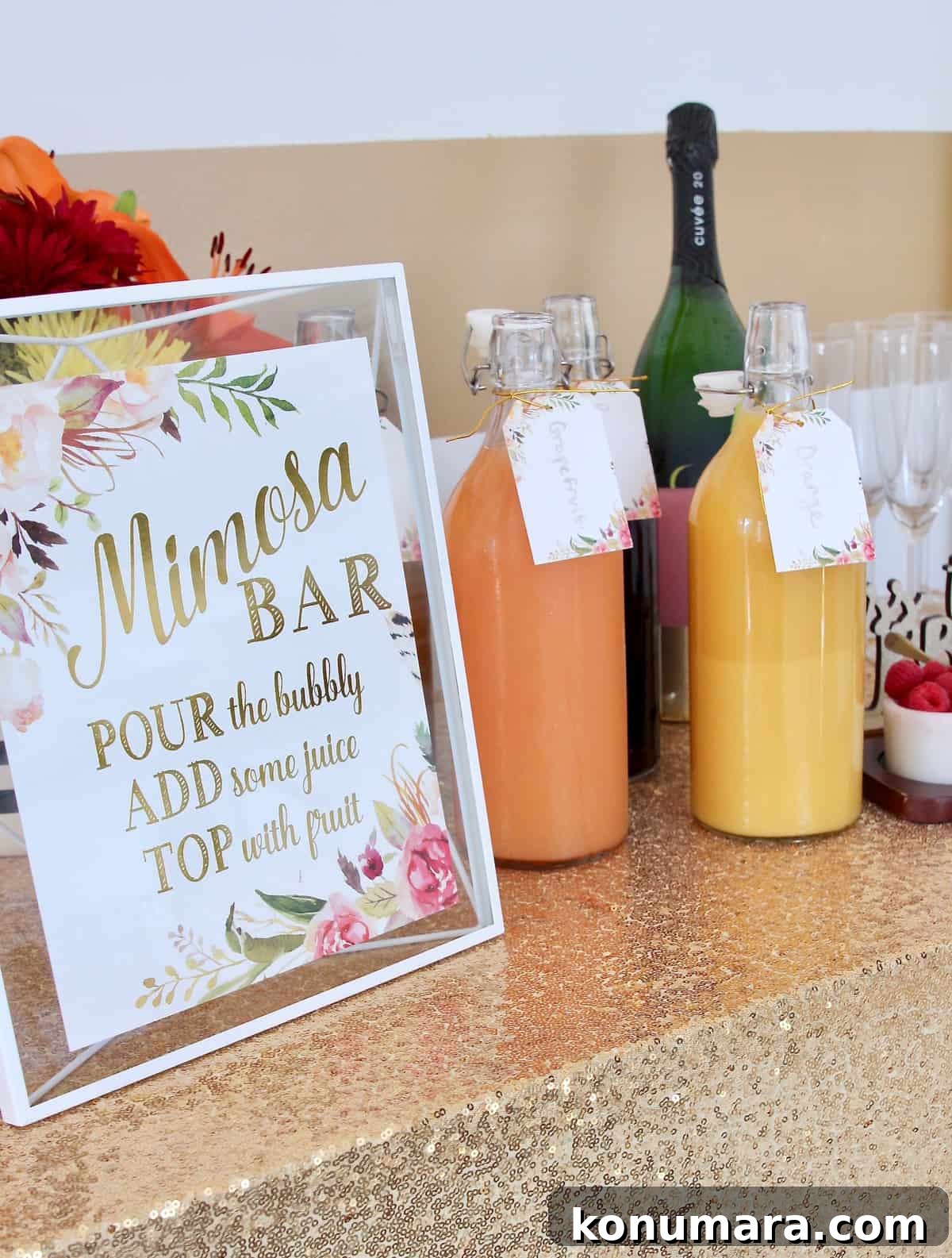 Mimosa bar sign and juices on bar with gold sparkly tablecloth