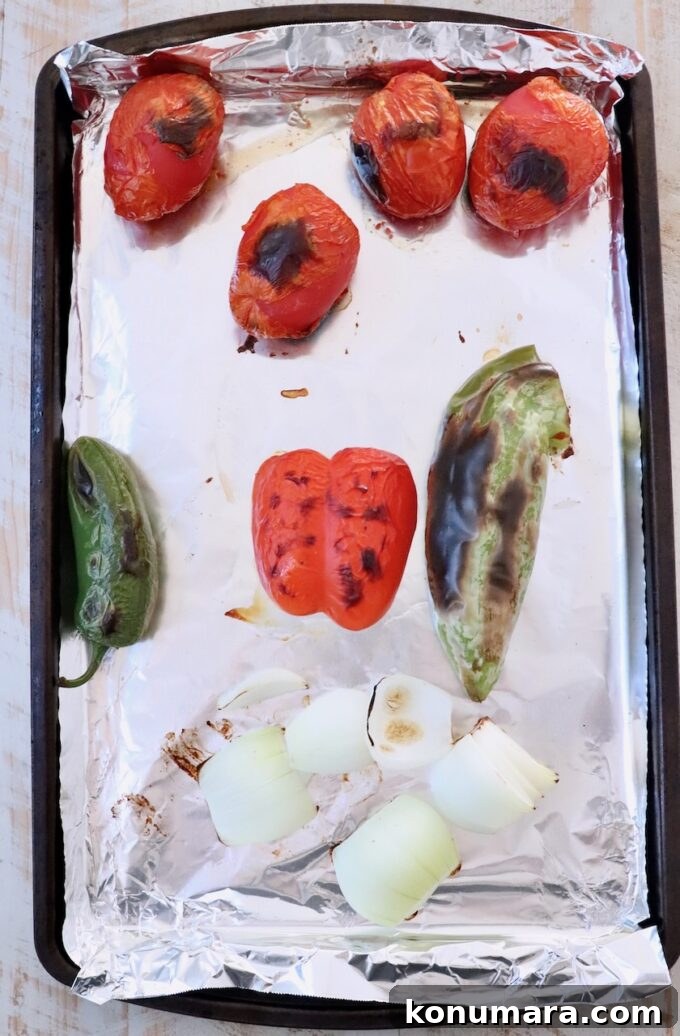 Fresh Peach Salsa with Jalapeño and Cilantro 5 roasted roma tomatoes, peppers and onions on a foil lined baking sheet