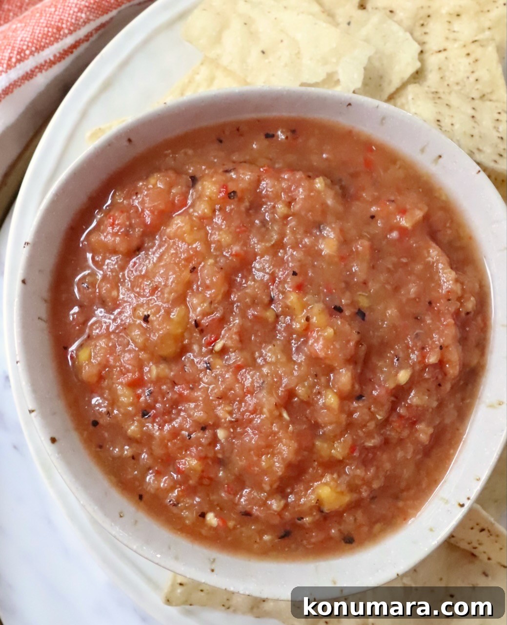 Fresh Peach Salsa with Jalapeño and Cilantro 8 peach salsa in a bowl with tortilla chips surrounding the bowl