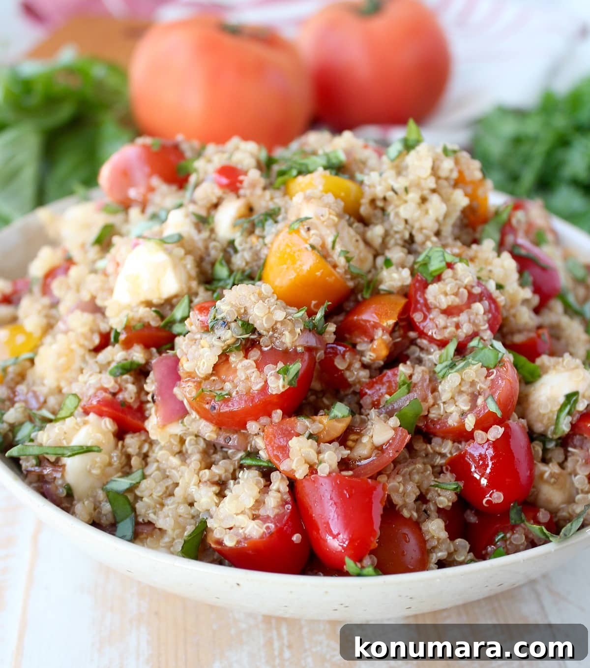 Quinoa Caprese Salad in a white bowl.
