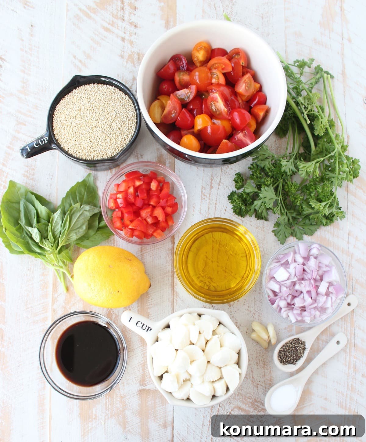 Quinoa Caprese Salad Recipe Ingredients in bowls on a wooden surface.