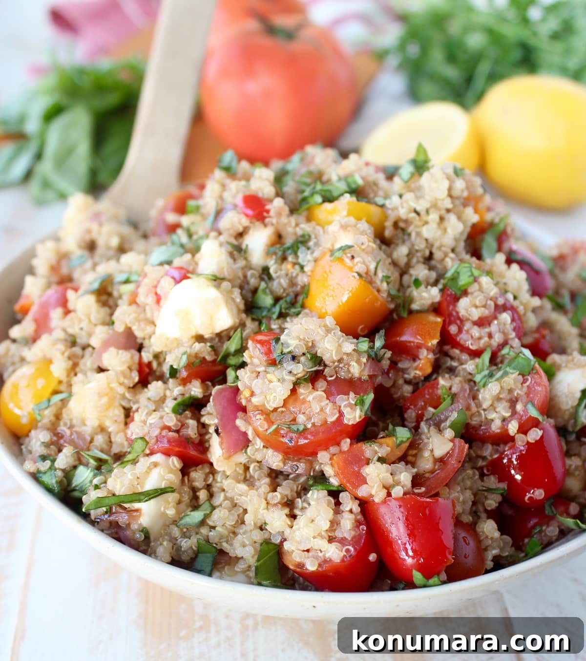 Quinoa Caprese Salad Recipe in a white bowl.