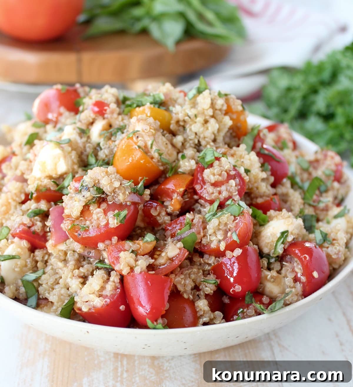 Quinoa Caprese Salad in a white bowl.