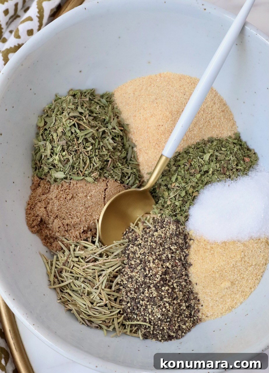 Savory Lamb Seasoning Blend for Roasts and Chops 2 dried herbs and spices separated in a bowl with a spoon