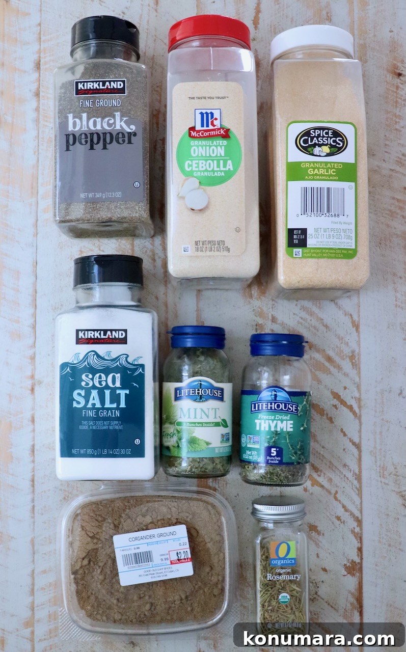 Savory Lamb Seasoning Blend for Roasts and Chops 3 dried herbs and spices in plastic containers on a white wood board