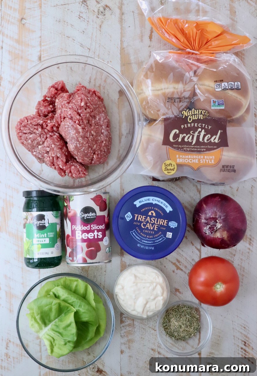 Grilled Mediterranean Lamb Burger with Mint Yogurt Sauce 3 ingredients for lamb burger on a white wood board