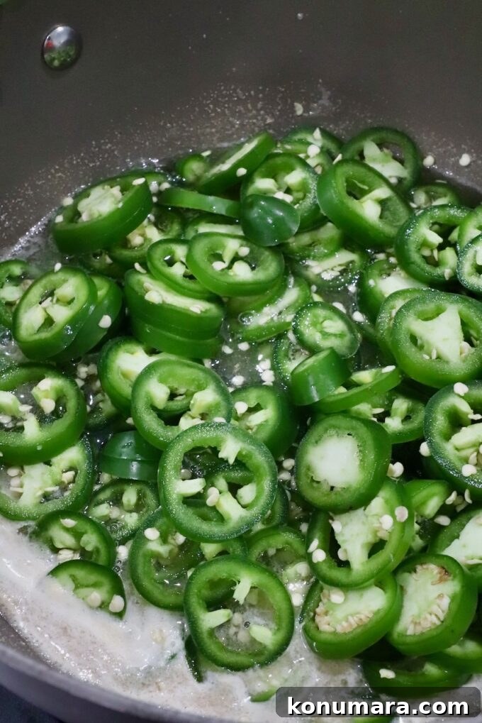How to Make Sweet and Spicy Candied Jalapenos 6 sliced jalapenos in a pot of boiling liquid