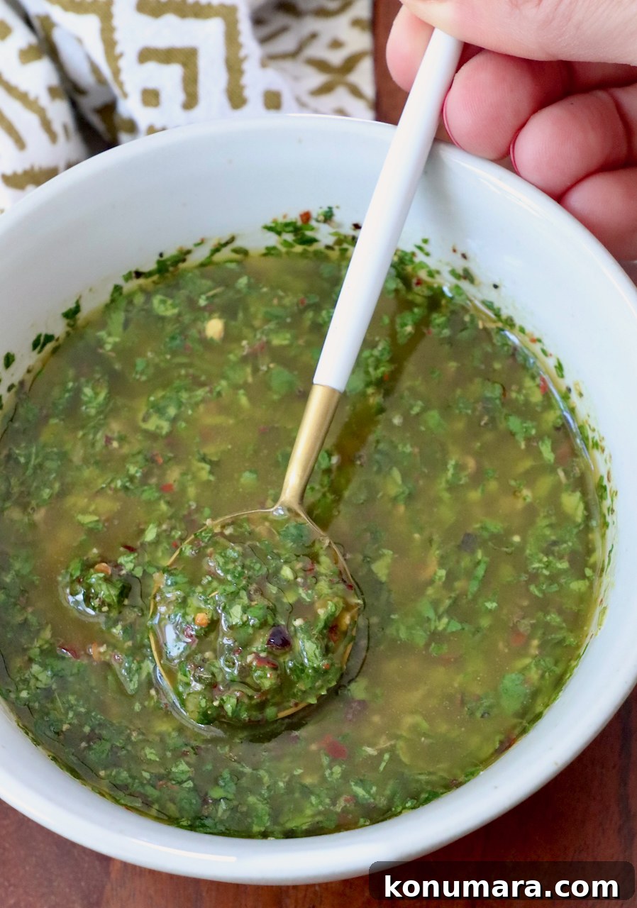 cilantro chimichurri sauce in a bowl with a small spoon