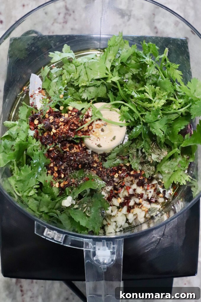 fresh cilantro with spices and garlic in a food processor