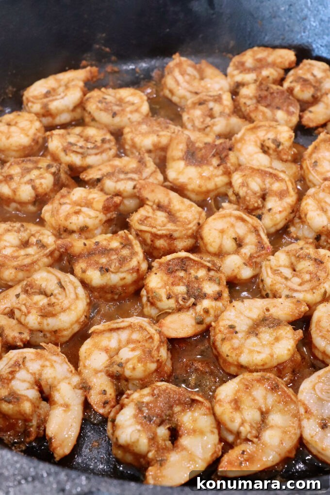 seasoned cooked shrimp in a cast iron skillet