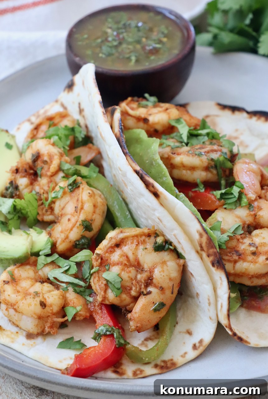 shrimp fajitas in tortillas on a plate