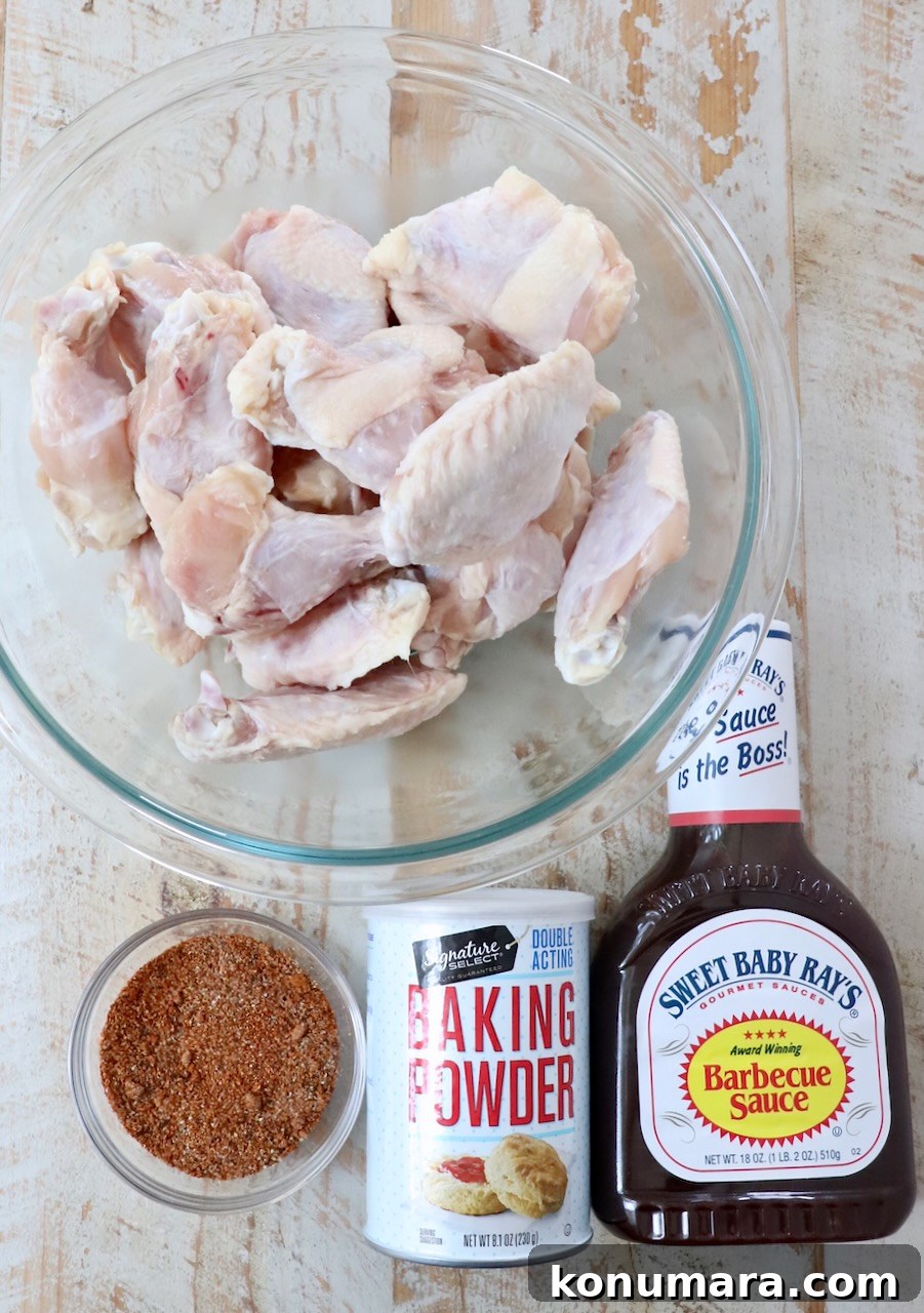 Crispy BBQ Chicken Wings with Tangy Glaze 3 ingredients for bbq chicken wings on a white wood board