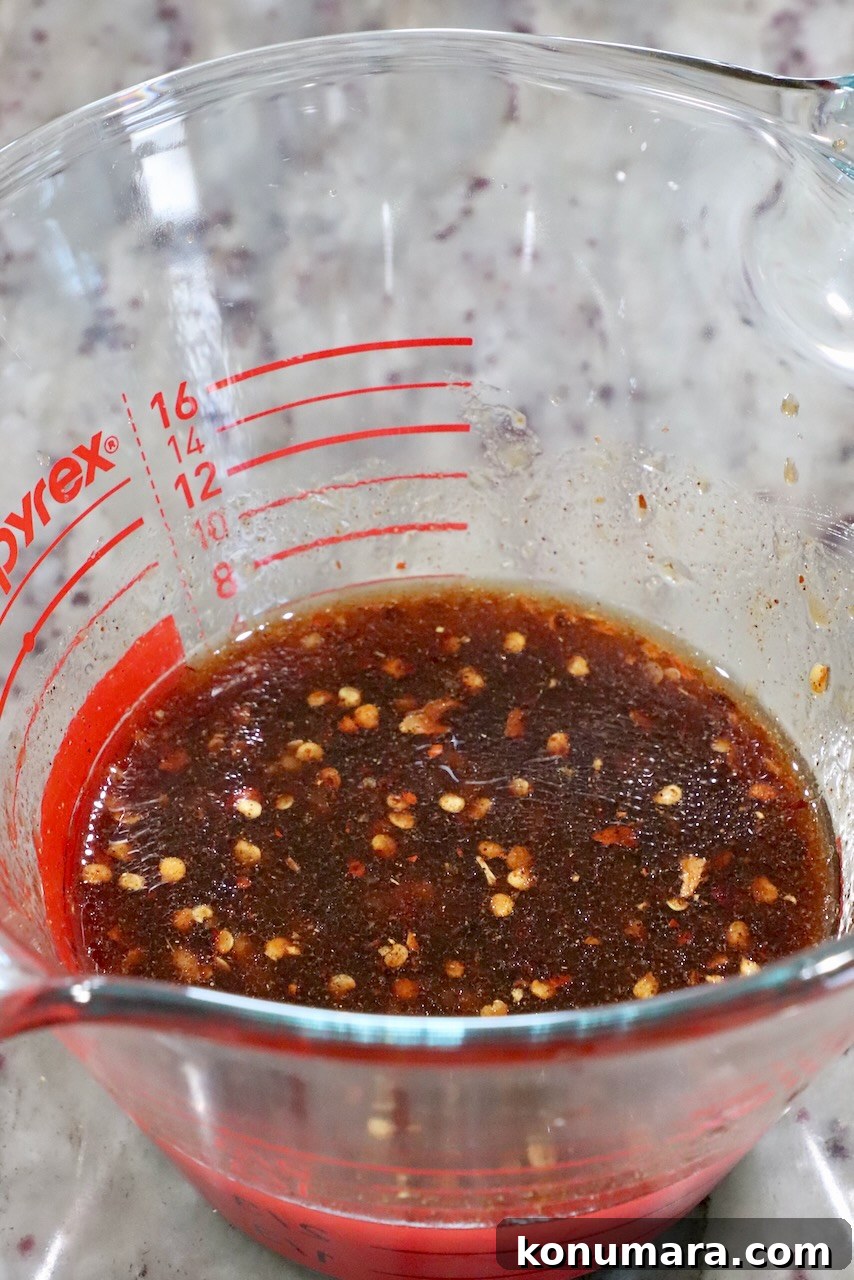 general tso sauce in a glass measuring cup