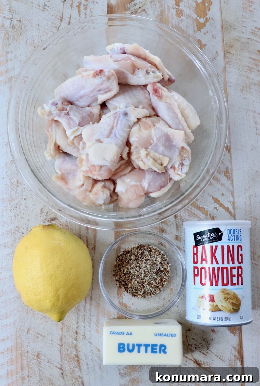 ingredients for lemon pepper wings on a white wood board