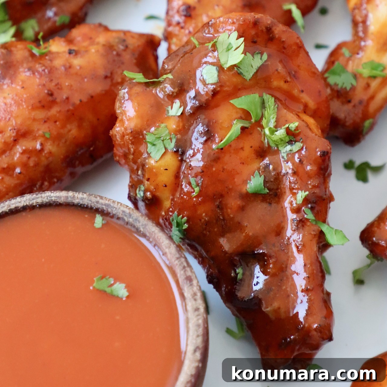 smoked chicken wings on plate tossed with buffalo sauce