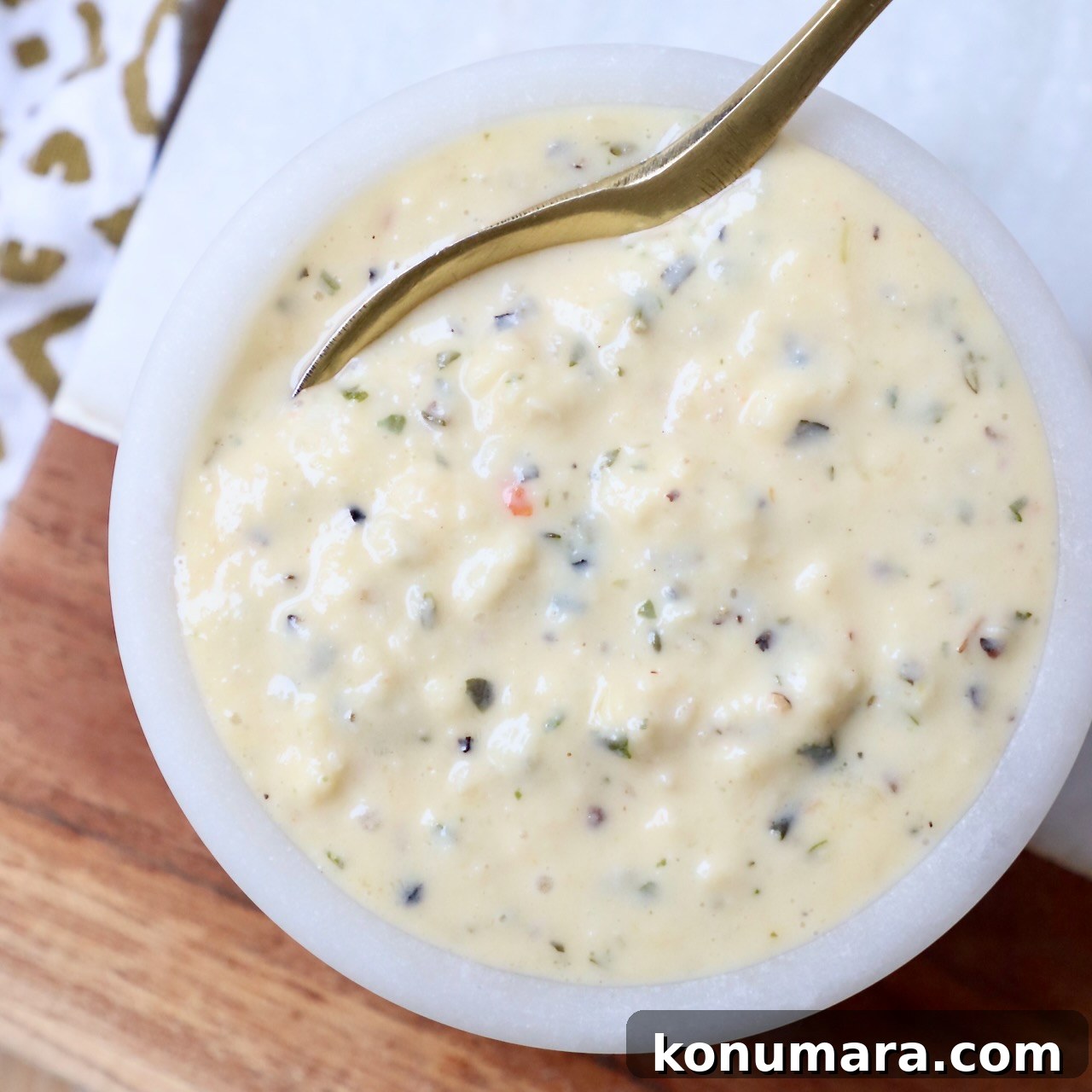 garlic parmesan sauce in bowl with spoon