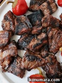 grilled steak bites on a plate with cherry peppers