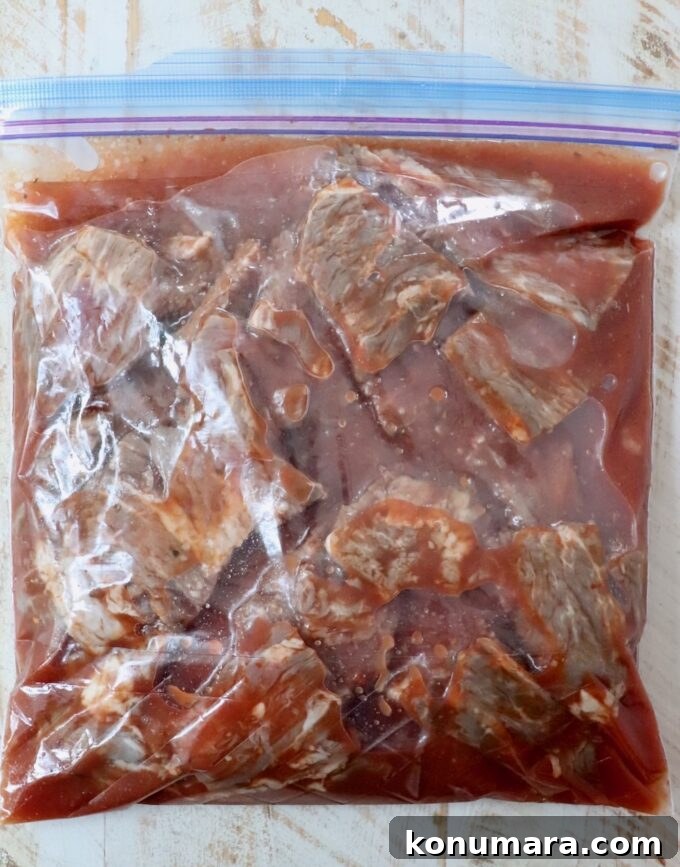 Grilled Steak Tips: Marinade, Sear, and Serve 4 steak tips marinating in a large plastic zipper bag