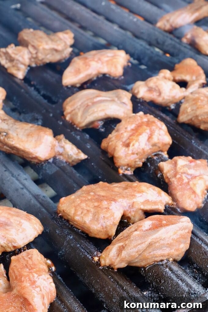 Grilled Steak Tips: Marinade, Sear, and Serve 5 marinated raw steak tips on a grill