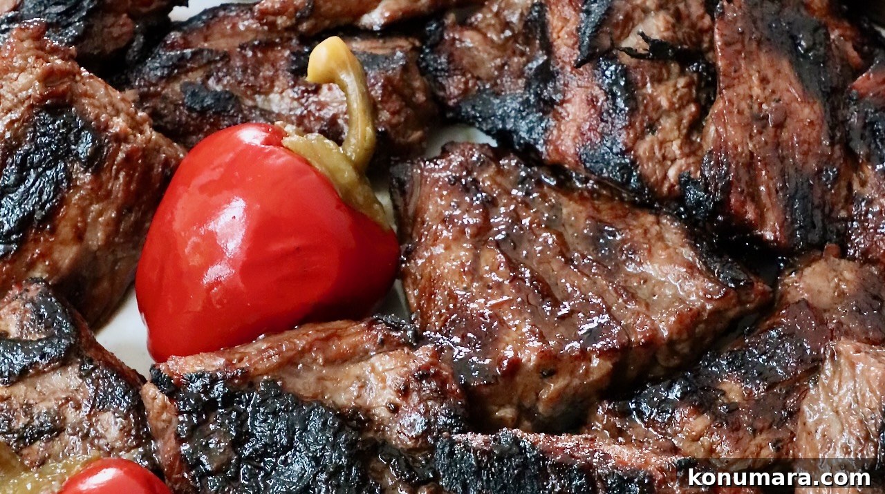 Grilled Steak Tips: Marinade, Sear, and Serve 7 grilled steak tips on a plate with cherry peppers