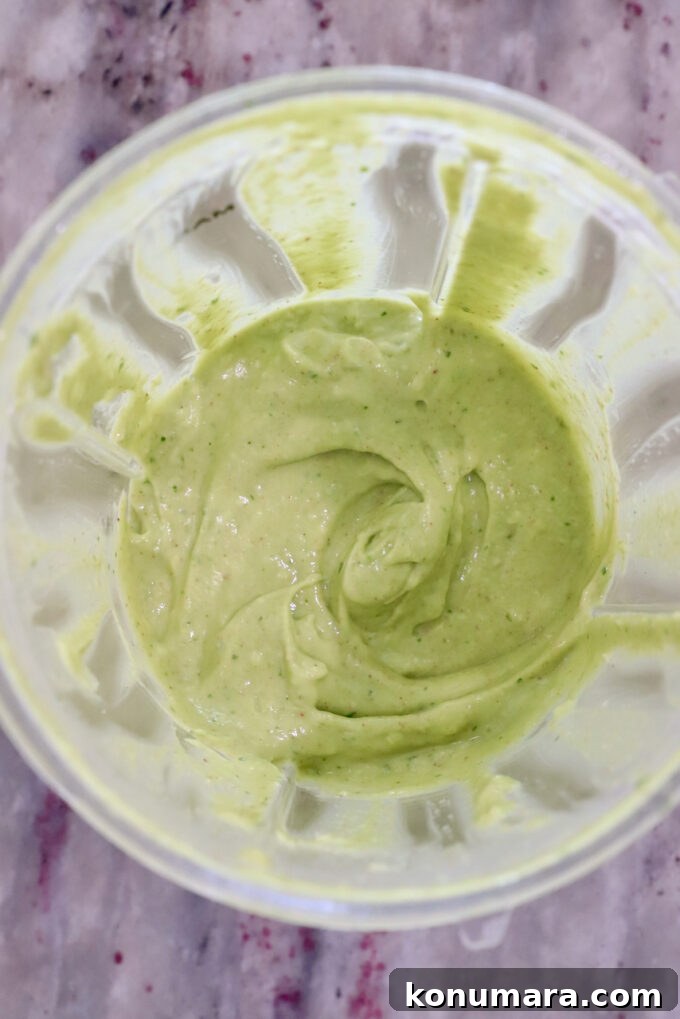 creamy avocado dressing in a plastic blender cup