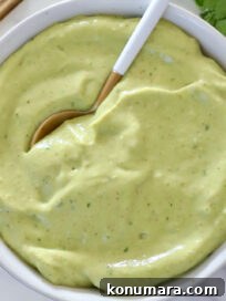 creamy avocado dressing in a bowl with a spoon