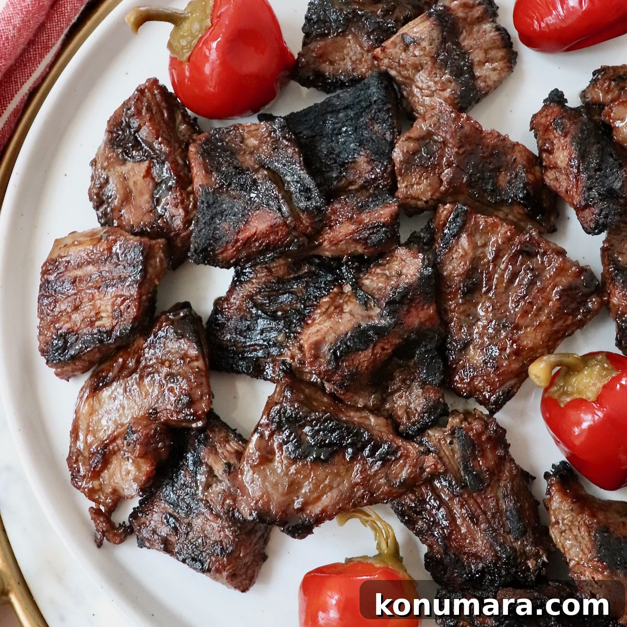 grilled steak bites on a plate with cherry peppers