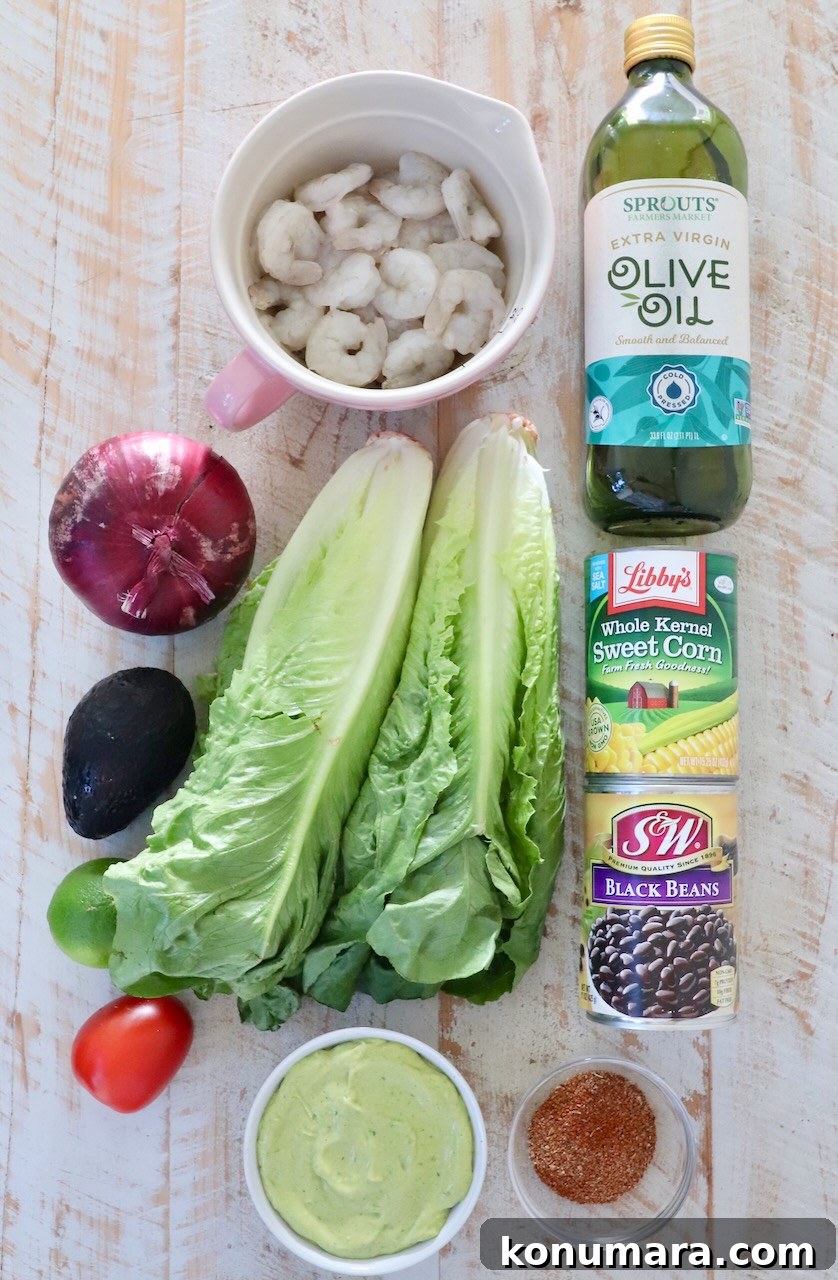 ingredients for Mexican shrimp salad on a white wood board