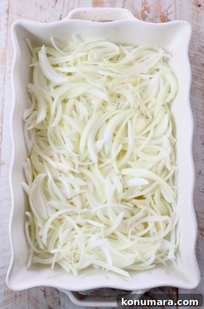 sliced onions in a white casserole dish