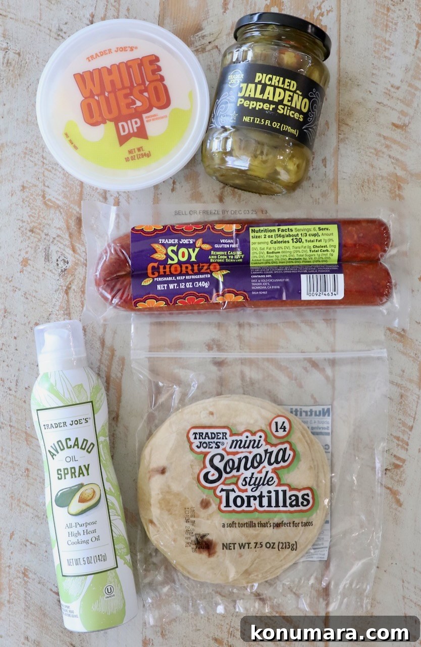 Crispy Chorizo Tacos with Melted Queso 3 A flat lay of Trader Joe's products on a wooden surface, including white queso dip, pickled jalapeños, soy chorizo, mini tortillas, and avocado oil spray.