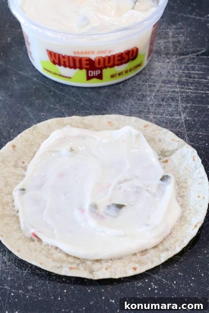 Crispy Chorizo Tacos with Melted Queso 5 queso dip spread on a tortilla