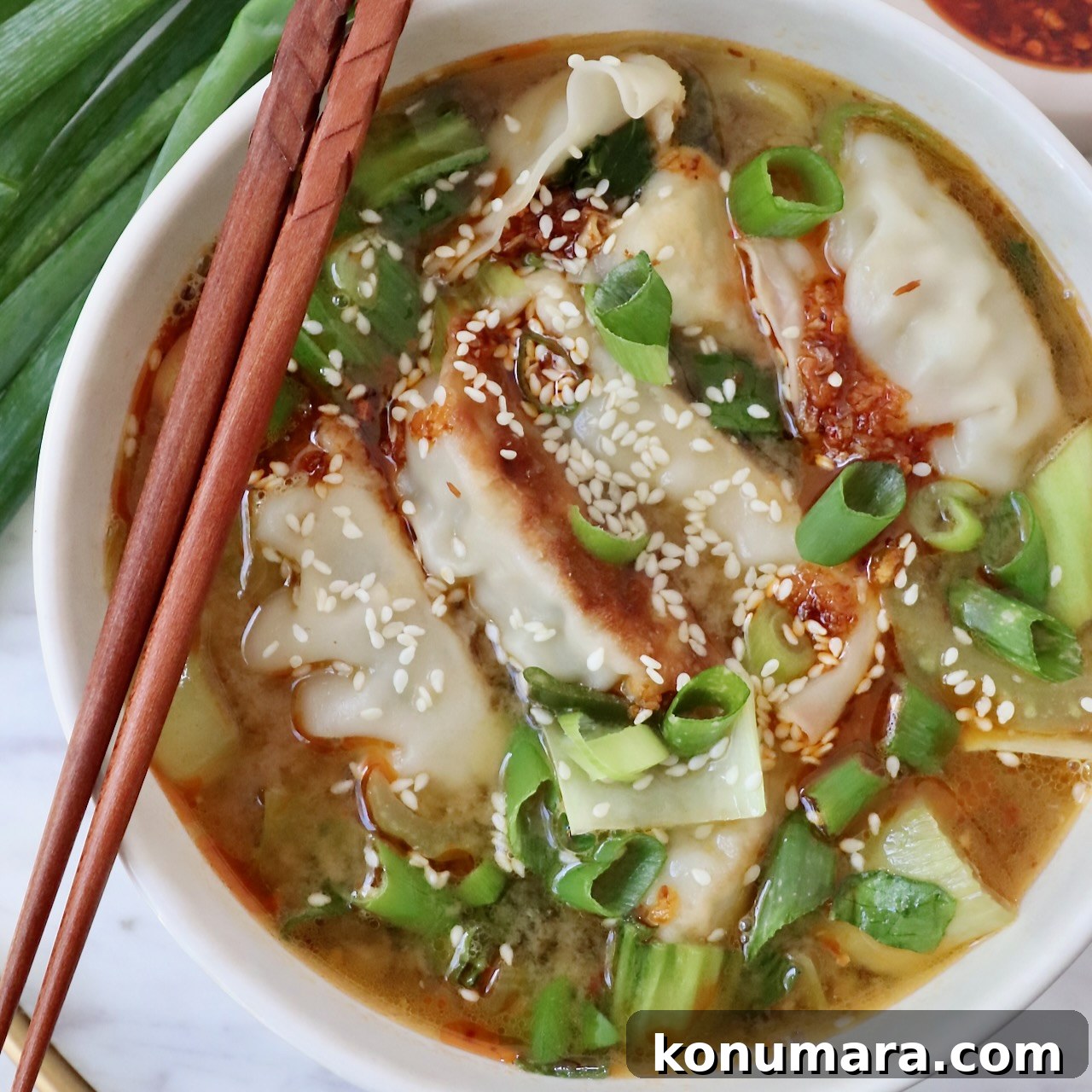 37 Cozy Fall Soup Recipes to Warm the Soul 9 gyoza soup in bowl with chopsticks on the side