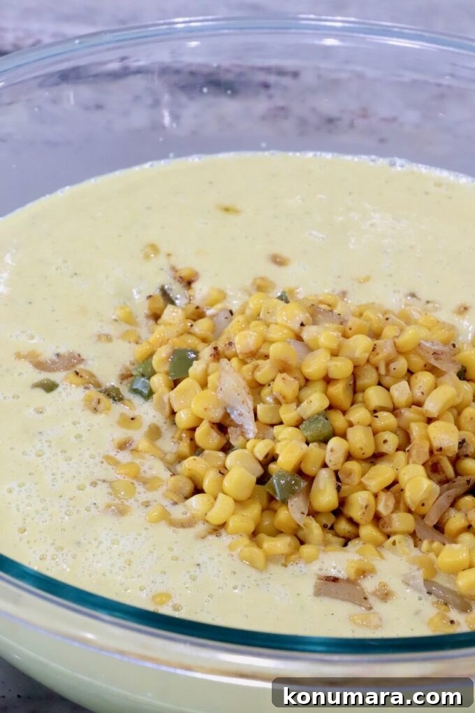 Mexican Street Corn Soup Recipe (Elote-Inspired) 8 pureed corn soup topped with roasted corn kernels in a large glass bowl