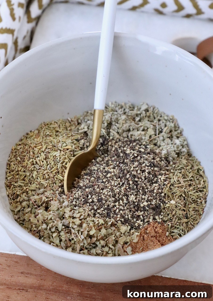 How to Make Poultry Seasoning at Home 5 poultry seasoning mixed up in a bowl with a spoon